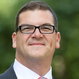 Portrait of Olly Robbins